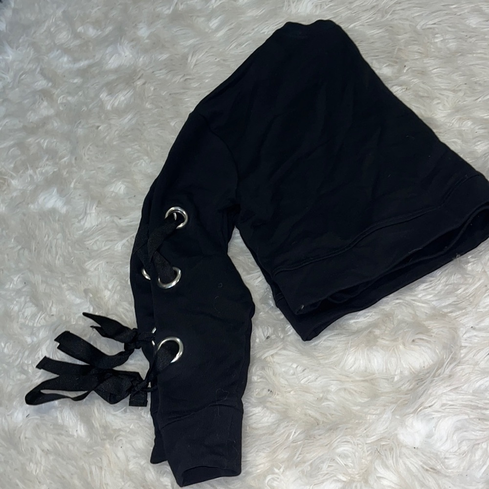 Black Crop sweater with cut out circles and ribbon on the sleeves. Gently worn